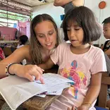 Volunteer teacher helping student 