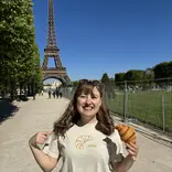 Woman standing beside eiffel tower
