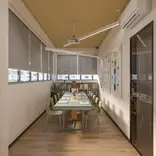The classroom is used for both online and in-person courses and has a maximum capacity of 10 students. It includes a study library with teaching materials, a projector, a writing board, and visual learning aids displayed on the walls.