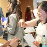 Two women talking in professional setting