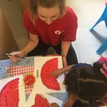 Volunteer coloring with students in Mexico