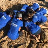 Teens volunteering on the beach in Greece