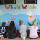 Volunteers painting mural in Fiji 