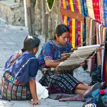 Guatemalan woman working on artistic projects.