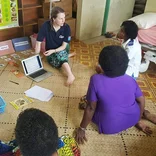 Volunteer working with community members in Fiji
