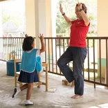 Intern working with a student in Thailand 