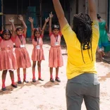 Interns leading a group of children in exercises in India