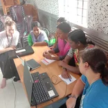 Women learning computer skills at a workshop in India 