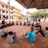 Interns playing with a group of students in India