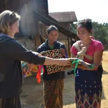 Intern working with group of women in Laos 