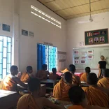 Intern leading class of monks in Cambodia