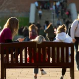 Students on bench on campus