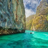 Boat in turquoise water in Phuket, Thailand