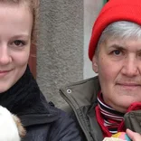 Two female volunteers holding dogs in Romania