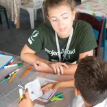 volunteer teaching students in Belize