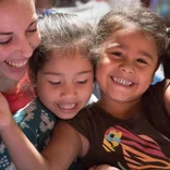 children hugging volunteer in Costa Rica