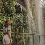 girl looking at plants and waterfalls