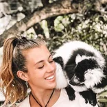 Female volunteer with a lemur at a wildlife conservation program in Africa