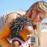 Female volunteer with a child in Cape Town