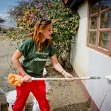 Projects Abroad volunteer painting a building in Arusha 