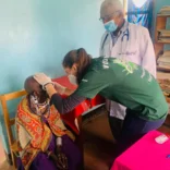 Projects Abroad intern working with a patient in Arusha