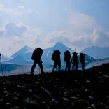 Students trek past mountain vista
