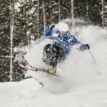 skier jumping off a lip