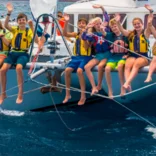 students waving on boat