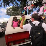 student high-fiving two local kids