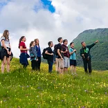 group of students lead by an IES Abroad professor trekking through the hills of the Swiss Alps