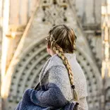 student looking back at an archway of La Sagrada Familia