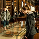 student looking at a display case inside the library at Trinity College Dublin
