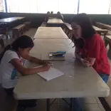 A volunteer working one-on-one with a student