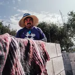 All Hands and Hearts volunteer in purple shirt on construction site in Mexico