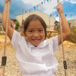 Filipino student swinging on new playground