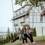 Students on a swing in Tallin smiling