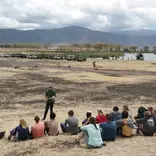 Students gather and learn from an instructor