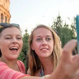 Students taking selfies with the Colosseum