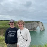 Students in front of beautiful hills and water in France