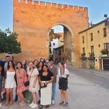 Students prepare for farewell dinner at medieval gate in Granada