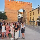 Students prepare for farewell dinner at medieval gate in Granada
