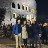 Participants pose in front of the Colosseum in Rome