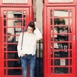 Participant in phone booth in London, England