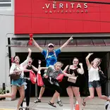 Students jumping for joy at la Universidad Veritas