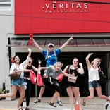 Students jumping for joy at la Universidad Veritas