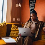 An Online MBA student attends class from her sofa