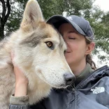 Volunteer Jarine with a resident Wolfdog