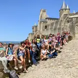 Students posing in front of castle in Toulouse