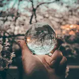 Hand holding crystal ball.