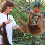 A woman helping a monkey in Peru